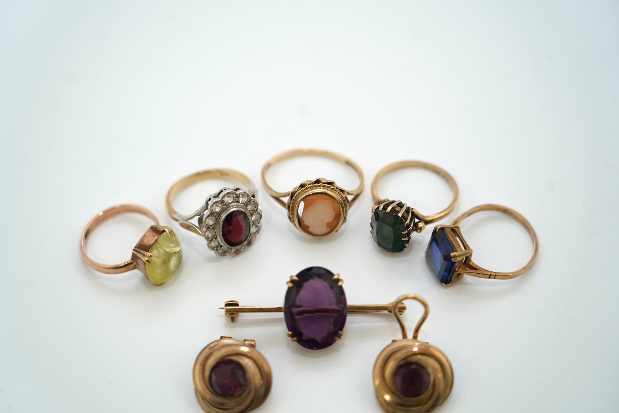Five assorted 9ct and gem set rings, including cameo shell, two pairs of ear clips including 9ct cameo shall with rolled gold clip and a yellow metal and gem set bar brooch. Condition - poor